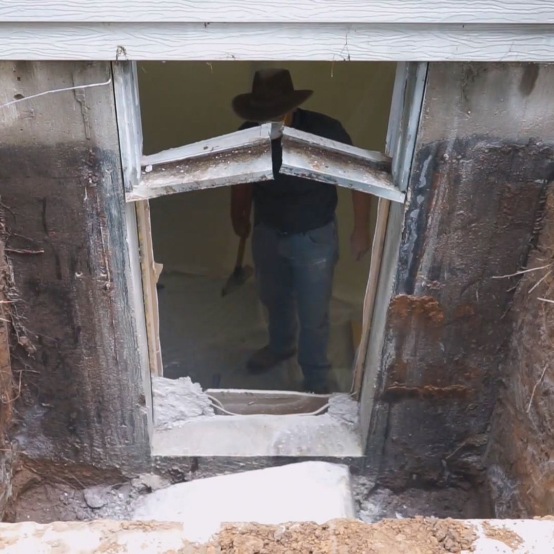 Opening cut into basement for egress window in Kansas.