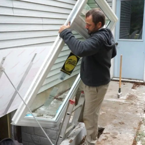 man installing an egress window
