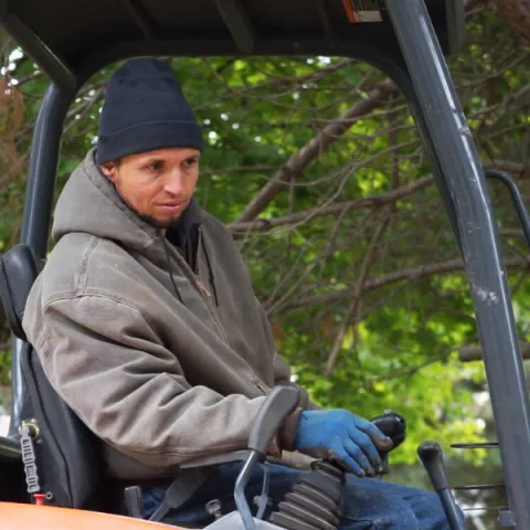 man operating equipment in cold weather